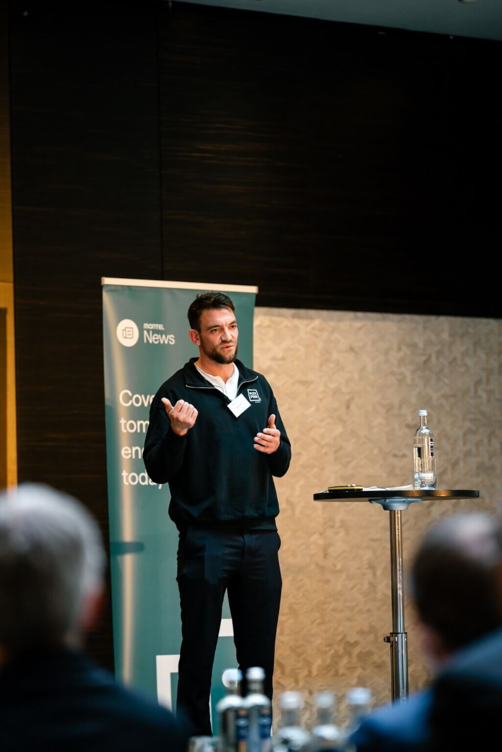Amani Joas, founder and CEO of FlexPower, giving a talk on renewable energy, battery storage, and power trading at an industry conference